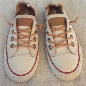 white converse with brown laces